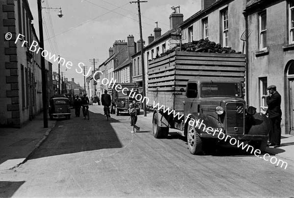 NARROW STREET WITH TURF LORRY